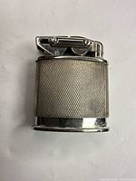 Front view of silver lift-arm petrol lighter showing textured body and mechanism
