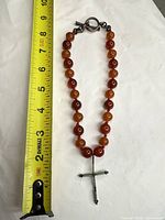 Full necklace laid next to tape measure showing length and toggle clasp