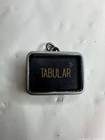 Front view showing "TABULAR" text on black insert