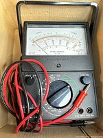 Multimeter with leads in box, overview