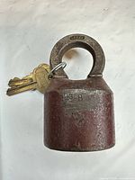 Front view of red Segal padlock with keys attached