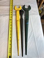 Three spud wrenches side-by-side with tape for scale