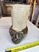 Full view of sculpture with tape measure showing height