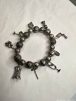 Full view of bracelet showing beads and wine-themed charms