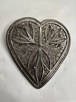 Front view showing heart shape and filigree leaf design