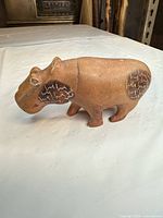 Three-quarter view of brown stoneware hippo figurine