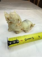 Full figure with tape measure showing roughly 4-inch length