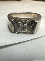 Front view of ring showing clear stone and band surface