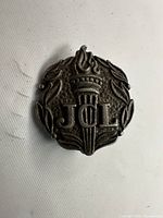 Front view showing JCL torch design and laurel wreath