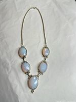 Full view of necklace showing five opalite stones and chain
