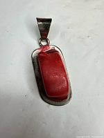 Front view showing red coral cabochon in silver setting