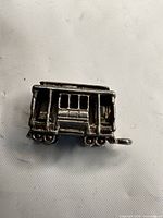 Front and side view of sterling silver streetcar charm