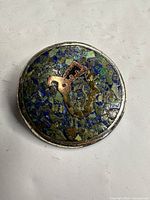 Front view of round sterling Taxco mosaic brooch