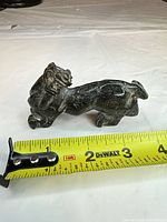 Side view with tape measure showing approx 4 inch length.