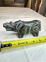 Profile view measuring 5 in length using tape measure