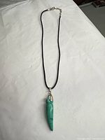 Full view of necklace showing pendant and adjustable cord