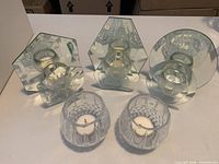 Group view of all three mirrored holders and two cut-glass holders