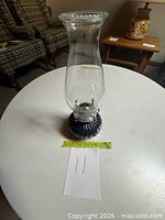 Full view of blue glass oil lamp with chimney