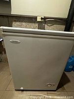 Front view of white Danby chest freezer showing door and control dial