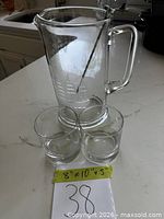 pitcher and two glasses with dimension note visible
