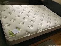 Full/double mattress on bed frame showing top surface and edge details
