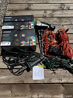 Overall lot with two boxed projectors, loose projector, and three extension cords