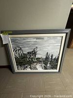 Framed painting resting against wall showing full artwork and frame