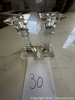 pair of clear crystal candlestick holders front view