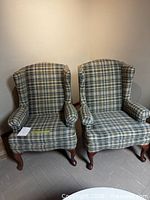 Front view of both plaid wingback armchairs