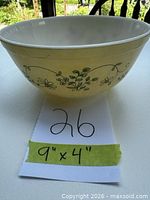 Side view showing yellow exterior with green floral design and measurement card