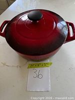 Top view of red enameled cast iron Dutch oven with lid and size note