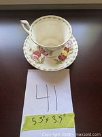 Teacup on saucer with measurement card