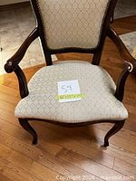 Front view of armchair showing seat, back, wood frame