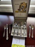 open box showing all six utensils with decorative handles