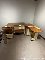 Overall view of sewing table with drawers open, cabinet door open and pull-out cart extended