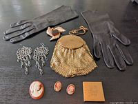 All items laid out: purse, gloves, jewelry pieces