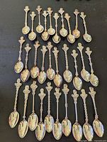 All 30 souvenir spoons laid out in rows