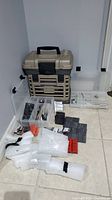 Overall view of toolbox, clear organizers, magnet pieces and packaging on floor