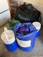 Sleeping bag, two Coleman coolers, Bestway bag, tarp visible