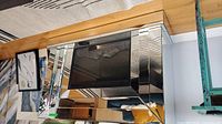 Front angled view of mirrored console table showing fireplace insert and surrounding mirrored panels