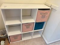 Front view of white nine-cube organizer with four fabric bins inserted