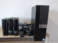 Dell OptiPlex 7050 SFF desktop beside three WD My Book drives with power bricks and cables