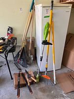 Group of string trimmer, rake, shovel, broom, misc tools