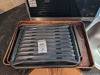 Stacked broiler pan set on rimmed baking sheets