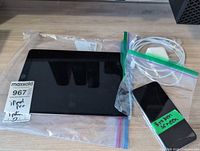 Overview: iPad, iPhone, cable, adapter in bags
