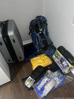 Overview of suitcase, hiking backpack, life jackets, butane stove