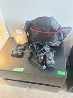 Lot overview showing both cameras, bag, cables and box
