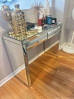 Front view of mirrored console table with drawer