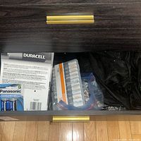 Drawer containing Duracell blister, HDX case, zip bag of loose batteries