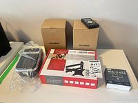 All boxed items: heater, remote, TV mount, earbuds